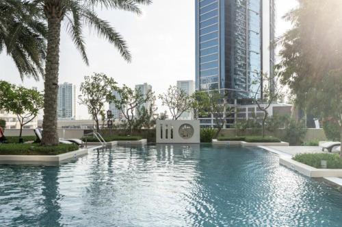 a swimming pool in a city with tall buildings at Luxury 3 BR - Direct View to Burj Khalifa in Dubai