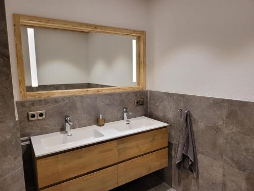 a bathroom with a sink and a mirror at Hideaway Zugspitz Berwang in Berwang