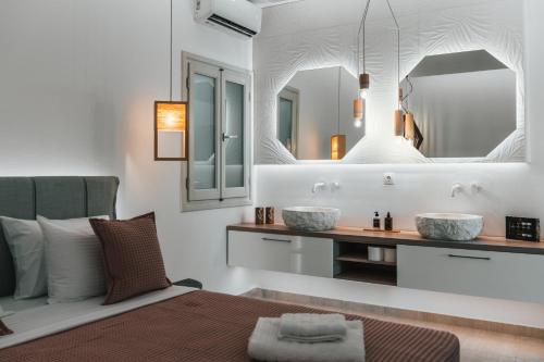 a bedroom with two sinks and a mirror at K suites ios in Ios Chora
