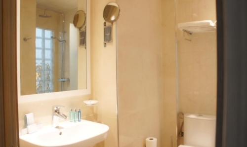a bathroom with a sink and a shower at Hotel Delphin-Nouadhibou in Nouadhibou