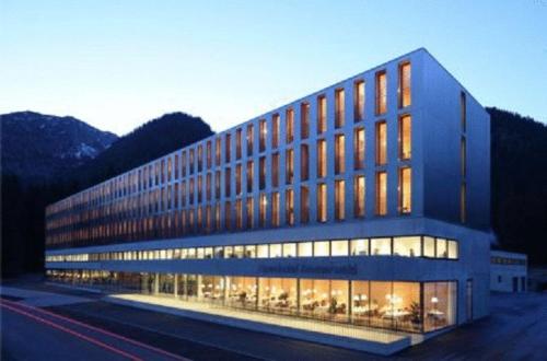 a large building with many windows on the side of it at Alpenhotel Ammerwald in Reutte