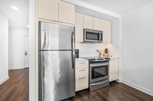 a kitchen with a stainless steel refrigerator and a stove at Global Luxury Suites at Reston Town Center in Reston