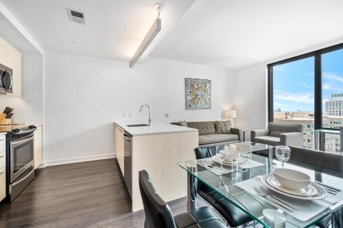 a kitchen and a living room with a table and chairs at Global Luxury Suites at Reston Town Center in Reston