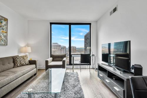 a living room with a couch and a tv at Global Luxury Suites at Reston Town Center in Reston