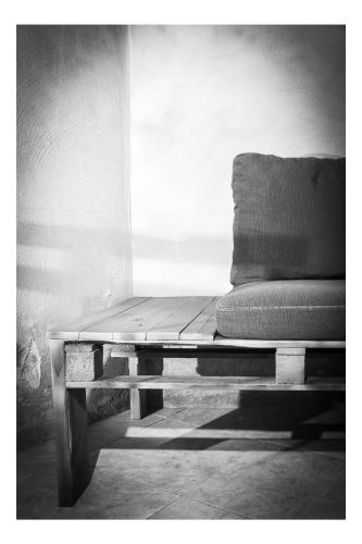 a couch sitting on a bench in a room at Central Perk Apartments-Antwerp in Antwerp