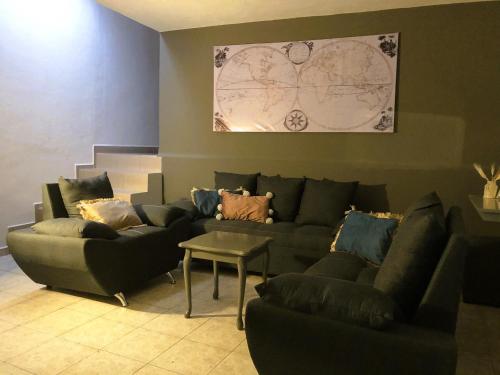 a living room with a couch and a table at Gualdras Departments with parking 7min to downtown in Guanajuato