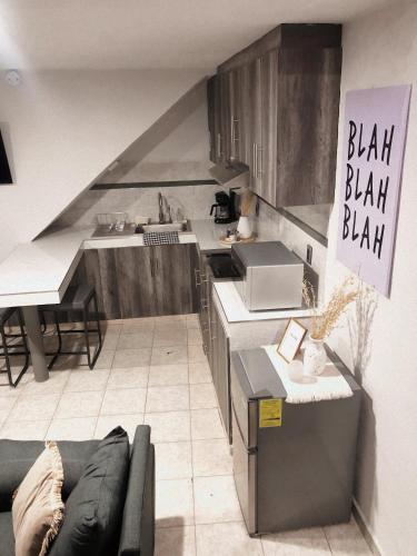 a kitchen with a sink and a couch in a room at Gualdras Departments with parking 7min to downtown in Guanajuato