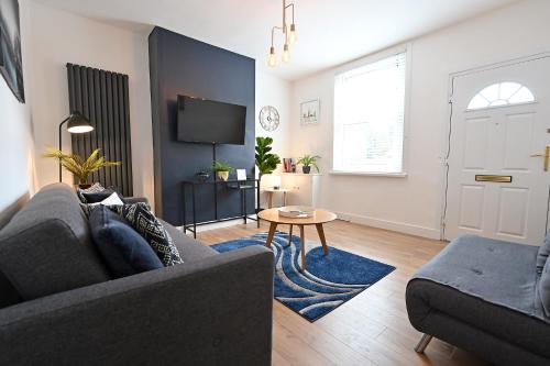 a living room with a couch and a table at The Coffee Pot Cottage in Town Centre FREE Parking in Stratford-upon-Avon
