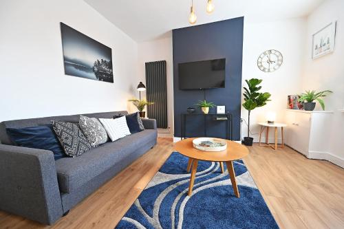 a living room with a couch and a table at The Coffee Pot Cottage in Town Centre FREE Parking in Stratford-upon-Avon