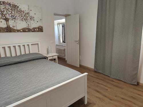 a white bedroom with a bed and a window at Alloggio Turistico C'era una volta in Roccalvecce