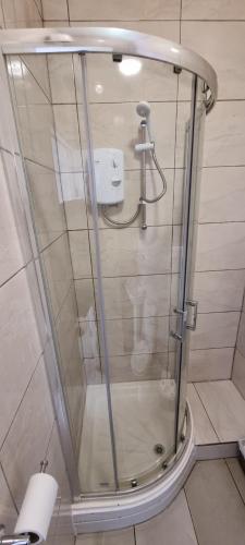 a shower with a glass door in a bathroom at Bloomsbury Apartments - Leicester in Leicester