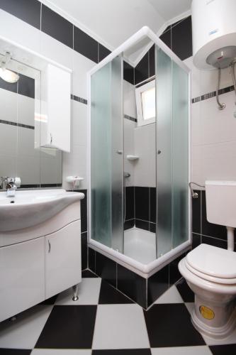 a bathroom with a glass shower and a toilet at Rooms with a swimming pool Metajna, Pag - 3306 in Zubovići