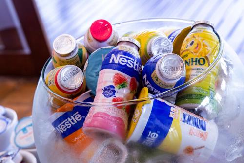 a bucket filled with bottles of soda and other drinks at Barra do Piuva Porto Hotel in Ilhabela