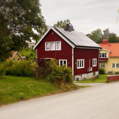a red barn sitting on the side of a road at Photoeverhome in Bengtsfors