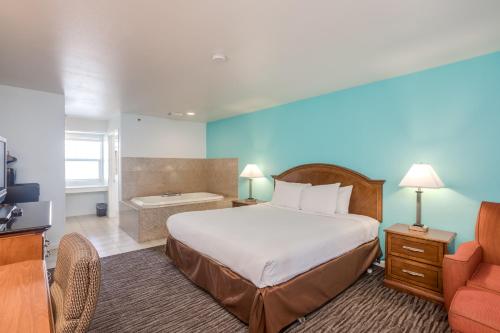a hotel room with a bed and a couch at Pacifica Beach Hotel in Pacifica