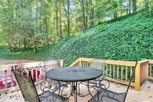 a table and chairs on a porch with a hill at Bear Nakid in Pigeon Forge