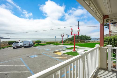 a balcony view of a parking lot with a view of the ocean at Pacifica Beach Hotel in Pacifica