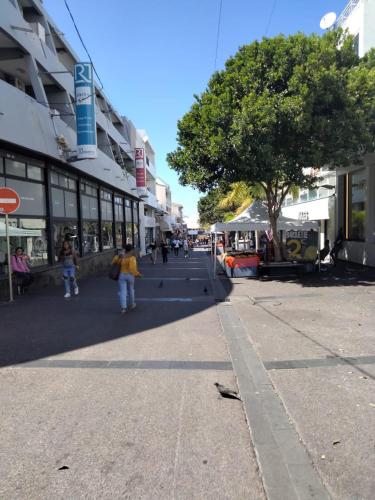 a group of people walking down a city street at Superbe T3 en plein cœur du centre ville in Saint-Denis