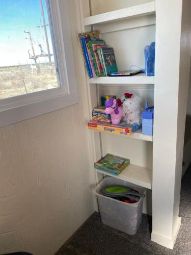 a corner of a book shelf with books at Grand Canyon Getaway! Cozy & easily accessible in Valle