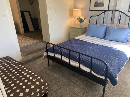 a bedroom with a bed with blue and white pillows at Grand Canyon Getaway! Cozy & easily accessible in Valle