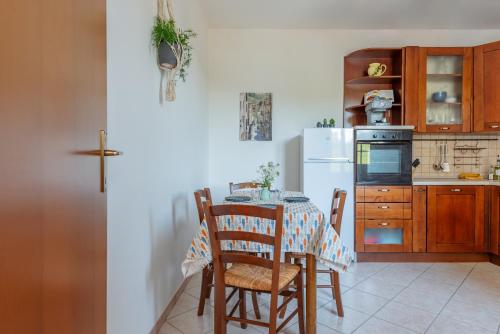 a kitchen with a table and a white refrigerator at Villa Ferranti Abruzzo in Montefino