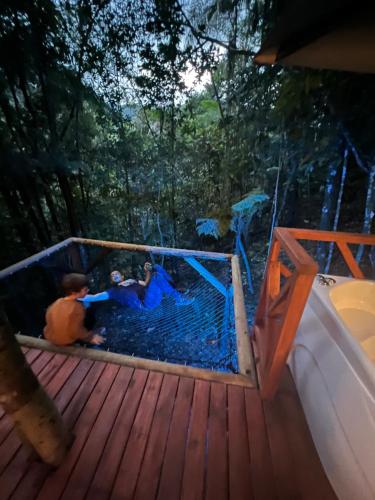 two children playing in a batting cage on a deck at ECO HOTEL RIO DE ORO in San Rafael