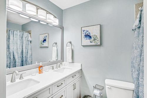 a bathroom with a sink and a mirror at Charming home near beach & golf with central AC & patio - dog-friendly in Palm Coast