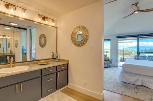 a bathroom with a sink and a large mirror at K B M Resorts- KGV-19P2 Beautifully designed two bed two bath Golf Villa with breath taking acqua marine views in the heart of Kapalua in Kapalua