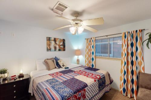 a bedroom with a bed and a ceiling fan at Water Wheel Resort Condo BLDGI 101 in New Braunfels