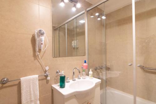 a bathroom with a shower and a sink and a shower at APART amento Asturiano 4 Mar del Plata in Mar del Plata
