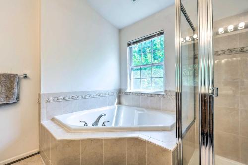 a bath tub in a bathroom with a window at Elkridge Townhome about 15 Mi to Dtwn Baltimore! in Elkridge