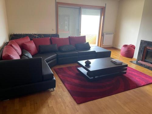 a living room with a couch and a coffee table at PORTO AGUDA BEACH ***** in Arcozelo