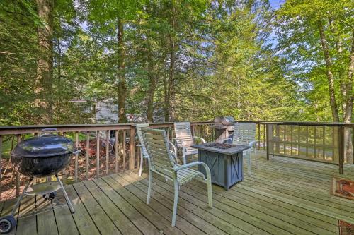 a deck with a bbq and chairs and a grill at Walk to Lake Wallenpaupack Greentown Getaway in Greentown
