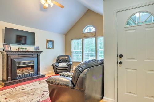 a living room with leather chairs and a fireplace at Charming Wasilla Retreat Walk to Lake Lalen! in Wasilla