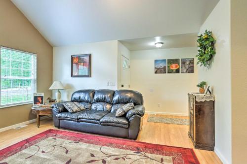 a leather couch in a living room with a rug at Charming Wasilla Retreat Walk to Lake Lalen! in Wasilla