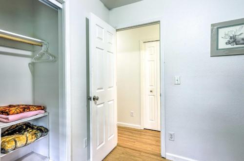 a walk in closet with a white door and a room at Charming Wasilla Retreat Walk to Lake Lalen! in Wasilla