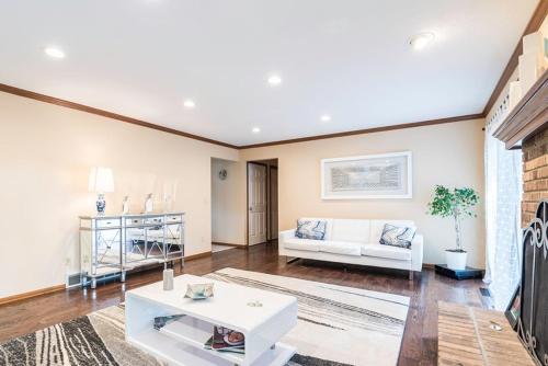 a living room with a white couch and a table at Luba's Peaceful Bedroom in Parma