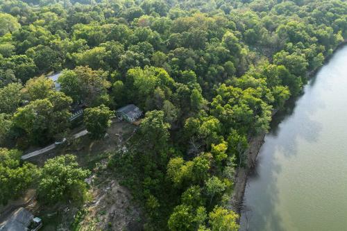 an aerial view of a forest next to a river at Private Eureka Springs Retreat with Hot Tub! in Eureka Springs
