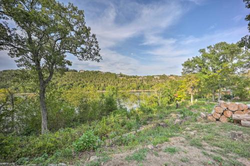 a view of a river with trees and a field at Private Eureka Springs Retreat with Hot Tub! in Eureka Springs