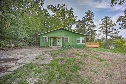 a green house with a bench in a yard at Private Eureka Springs Retreat with Hot Tub! in Eureka Springs