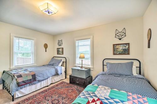 a bedroom with two beds and two windows at Pet-Friendly Saranac Lake Retreat with Deck and Yard in Saranac Lake