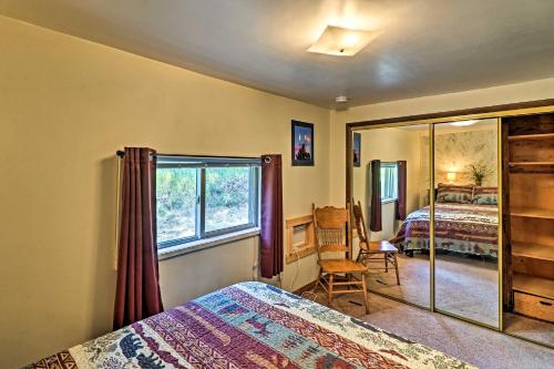 a bedroom with a bed and a window and a mirror at Cozy Montana Lake View Getaway - Fish and Hike! in Kalispell