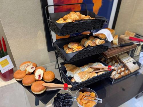 two baskets filled with different types of bread and pastries at Best Western Plus Hotel Sydney Opera in Paris
