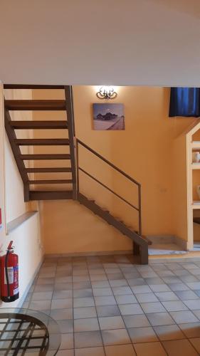 a living room with a staircase in the ceiling at Life Hotels Residence dei Baroni in Siracusa