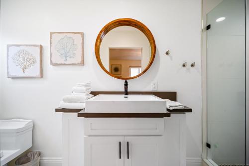 a bathroom with a white sink and a mirror at The Little Crab Shack in Dana Point