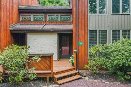 a house with a wooden staircase leading to the front door at Big Boulder Bliss in Lake Harmony