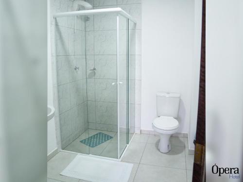 a bathroom with a shower with a toilet at Opera Hotel in Pôrto União