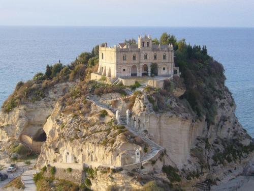 a castle on a cliff in the ocean at Hotel Virgilio in Tropea