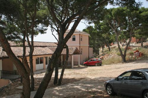 a car parked in front of a house at Apartments by the sea Rogoznica - 3094 in Rogoznica