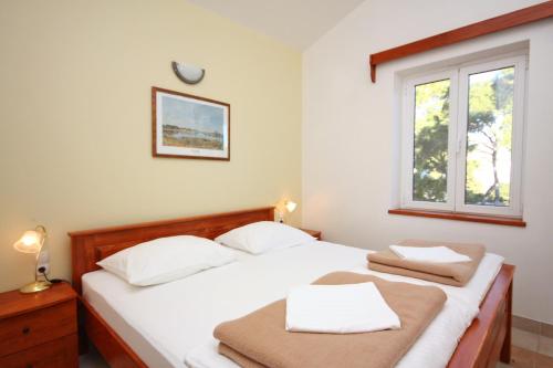 a bedroom with a bed with two towels on it at Apartments by the sea Rogoznica - 3094 in Rogoznica